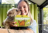 Customer photo from Kate P.: a woman holding her small terrier and a TheraPetMD box